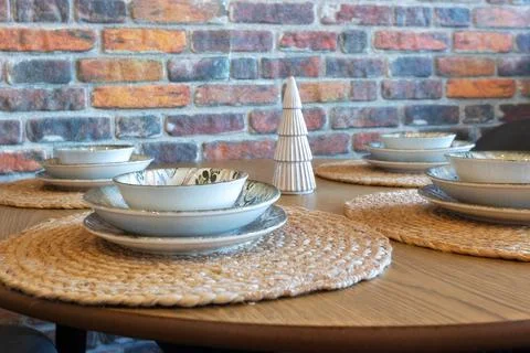 Table setting with ceramic bowls on jute placemats Stock Photos