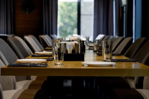 Table setting. Close-up photo of empty glasses, plates and spoons Stock Photos