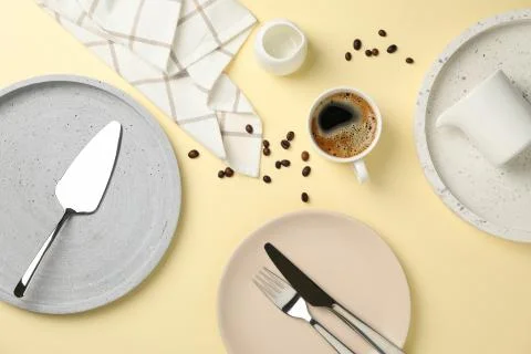 Table setting with cup of coffee on beige background, top view 写真素材