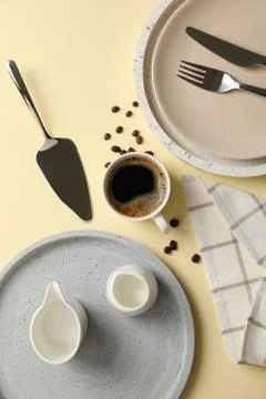 Table setting with cup of coffee on beige background, top view 写真素材