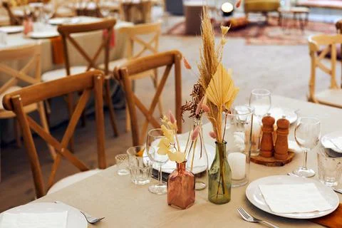 Table setting with dry flower bouquets in restaurant Stock Photos