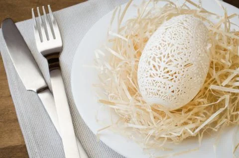 Table Setting for Easter Celebration. Carved Egg. Stock Photos