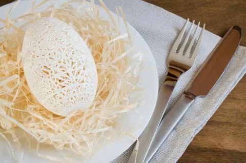 Table Setting for Easter Celebration. Carved Egg. 스톡 사진