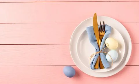 Table setting for Easter feast. Easter eggs, tulips and cutlery top view fl.. Stock Photos