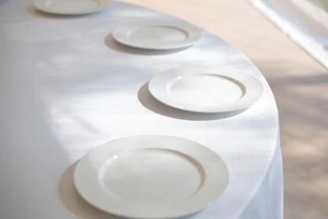 Table setting element empty plates with cutlery on white tablecloth. Stock Photos