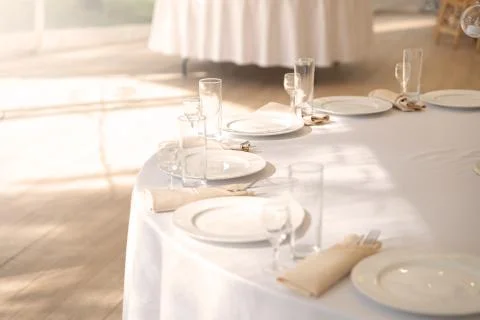 Table setting element empty plates with cutlery on white tablecloth. Stock Photos