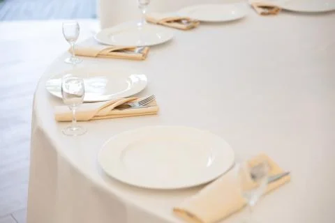 Table setting element empty plates with cutlery on white tablecloth Stock Photos