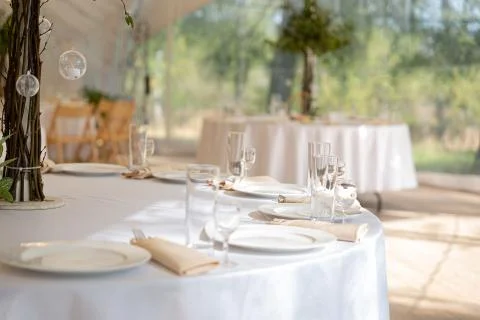 Table setting element empty plates with cutlery on white tablecloth Stock Photos