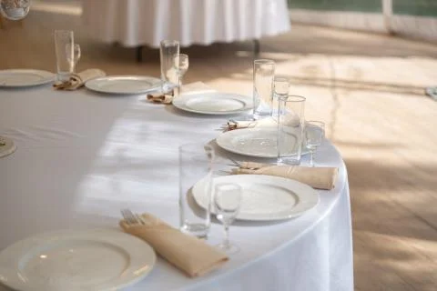 Table setting element empty plates with cutlery on white tablecloth Stock Photos