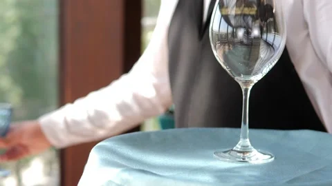 Table setting in an elite restaurant close-up. Men's hands arrange beautiful Video stock 156429344
