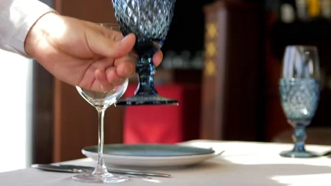 Table setting in an elite restaurant close-up. Men's hands arrange beautiful Stock-Footage 156429486