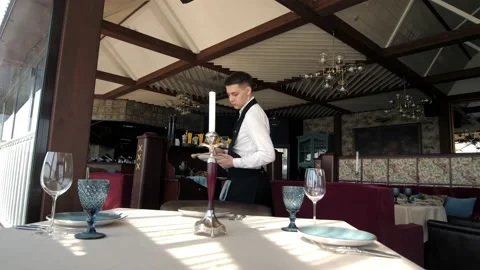 Table setting in an elite restaurant. Men's hands arrange beautiful clean and Stock Footage 156429579