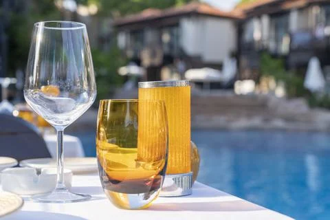Table setting. empty glasses on the background of the pool. service of guests at Stock Photos