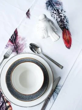 Table setting. Flowers, plates, bright tablecloth with print Stock Photos