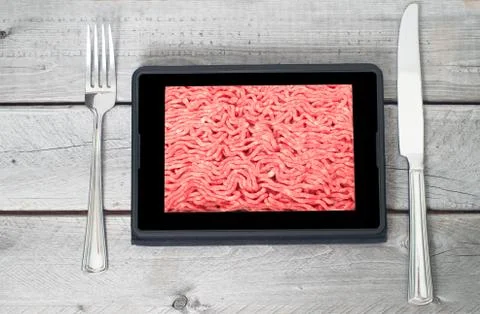 Table setting with fresh raw ground lean beef on a tablet screen Stock Photos