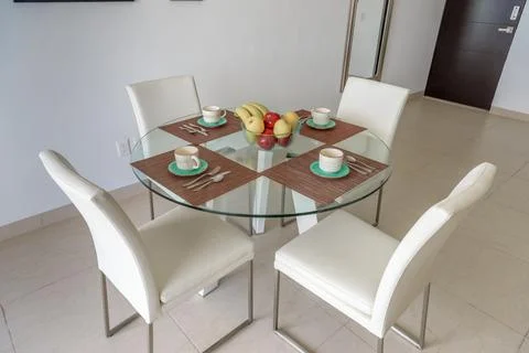 Table setting with fruit bowl in dining room Stock Photos