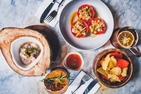 Table setting full of latin dishes such as ceviche, tortilla chips, tostadas, Stock Photos