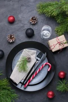 Table setting with gift boxes,candy cane and holiday decorations top view. Foto stock