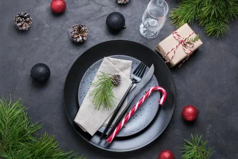 Table setting with gift boxes,candy cane and holiday decorations top view. Stock Photos