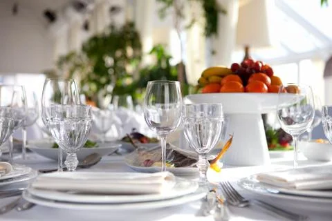 Table setting glasses and a fruit basket Stock Photos