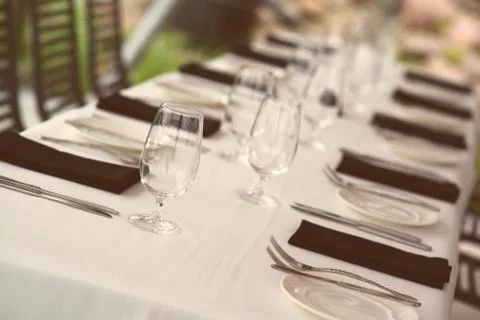 Table setting. Glasses and plates on table in a restaurant Stock Photos
