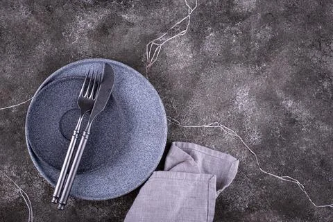 Table setting on grey concrete background Stock Photos