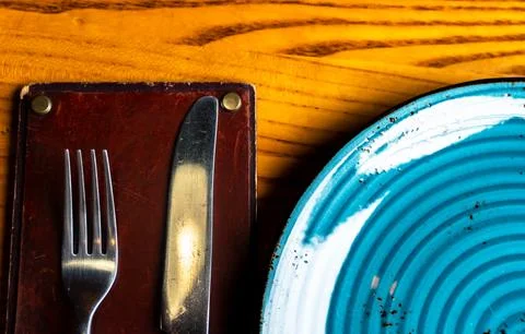 Table setting - knife, fork and plate close-up Stock Photos