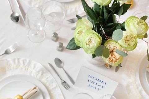 Table setting for Nobel prize day with roses, top view Stock Photos