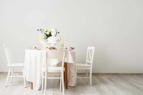 Table setting for Nobel prize day with Greek statuette and roses in light roo Stock Photos