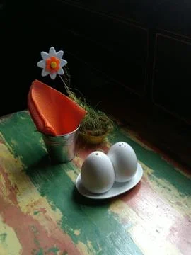 Table setting in orange-green color scheme with a flower. There is free space Stock Photos