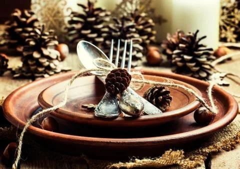 Table setting with pine cones, candles and snowflakes, pottery, rustic style, Stock Photos