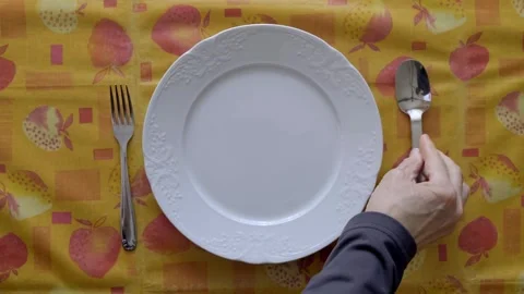 Table Setting With Plate and Cutlery on Vibrant Tablecloth Stock Footage 307742362