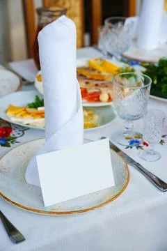 Table setting. a plate with a napkin and a card for the guest's name. Stock Photos