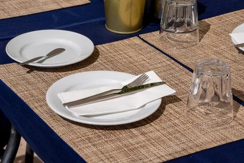 Table Setting with Plates and Cutlery in a Restaurant. Stock Photos