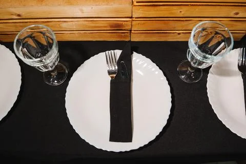 Table setting with plates and glasses ready for a meal in a restaurant Stock Photos