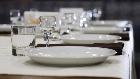 Table setting. Plates, glasses and glasses on the festive table in the Stock Footage 104547136