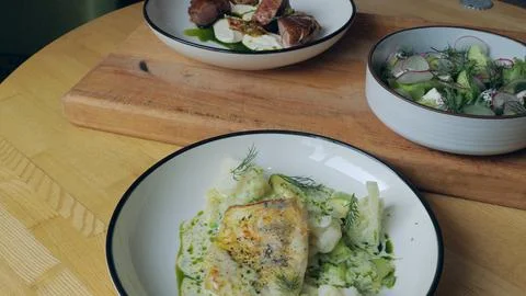 Table setting. Ready-made dishes, meat, fish and vegetable salad on the table Foto stock