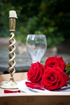 Table setting with red roses on plate - celebrating Valentine's Stock Photos
