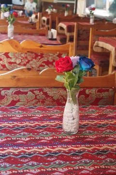 Table setting in a restaurant with flowers on the table Stock Photos