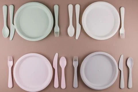 Table setting in a restaurant for four persons with a plate spoon fork knife Stock Photos