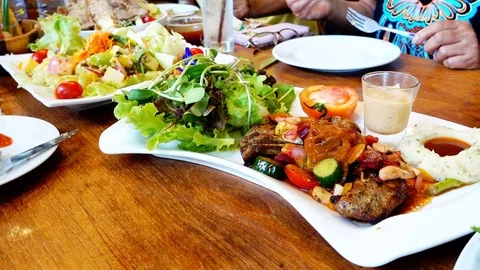 Table setting in restaurant, Fresh steak plate Stock Footage 72907546