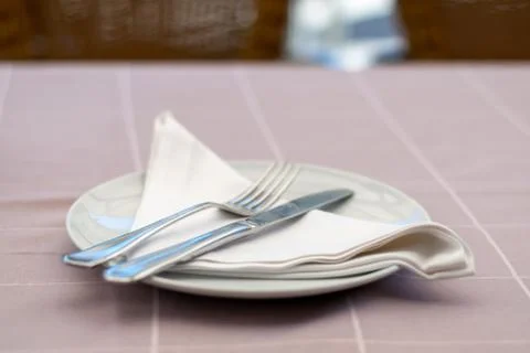 Table setting in a restaurant with reserved card. Stock Photos