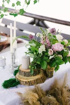 Table setting for a romantic dinner. Beautiful flowers in a vase on the table Stock Photos