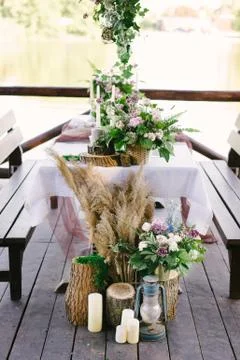 Table setting for a romantic dinner. Beautiful flowers in a vase on the table Stock Photos
