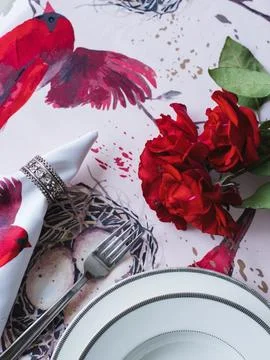 Table setting with a rose. Napkin with a bird and an angel Stock Photos