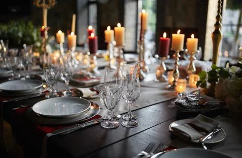 Table setting set with candles and flowers Stock Photos