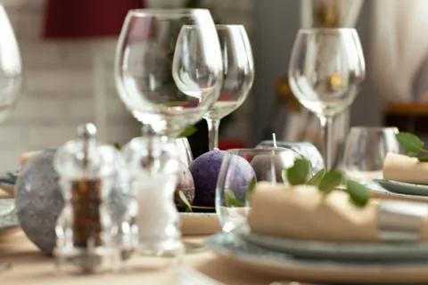 Table setting set with candles and plant branches Stock Photos