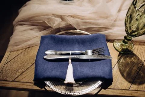 Table setting with silver fork and knife on blue cloth Stock Photos