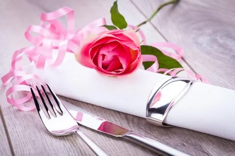 Table setting with a single pink rose Stock Photos