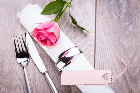 Table setting with a single pink rose Stock Photos